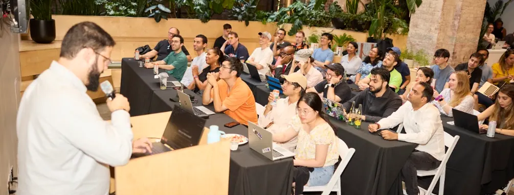 Engaged audience listening to a developer talk in a studio venue
