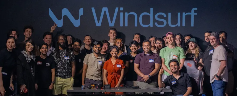 Community members gathered for a group photo under a glowing logo
